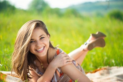 Ragazza sorridente distesa sul prato