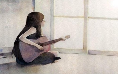 Ragazza seduta per terra con la chitarra