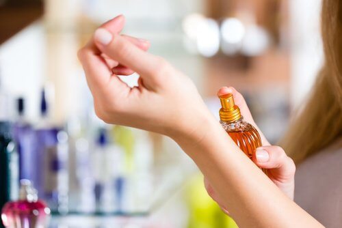 donna che spruzza profumo soffre di emicrania
