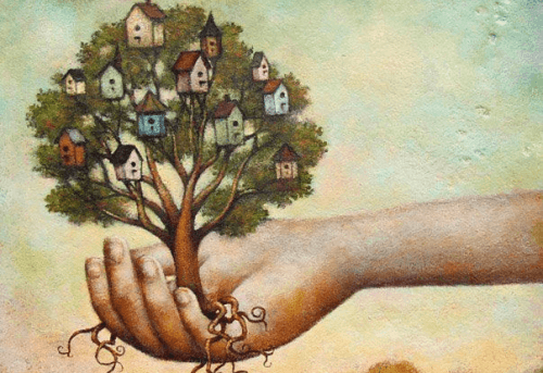 mano con albero con case sui rami fiducia in sé