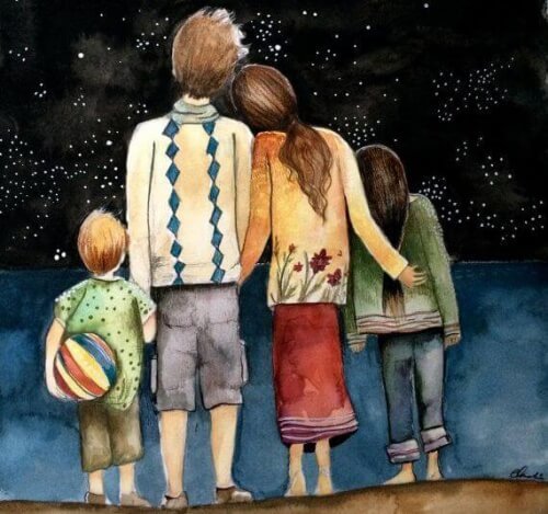 Famiglia di spalle che guarda il cielo stellato