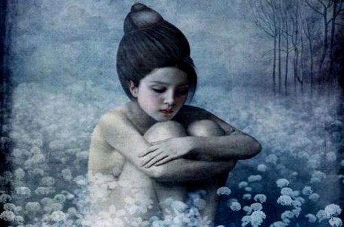 Ragazza con ginocchia al petto