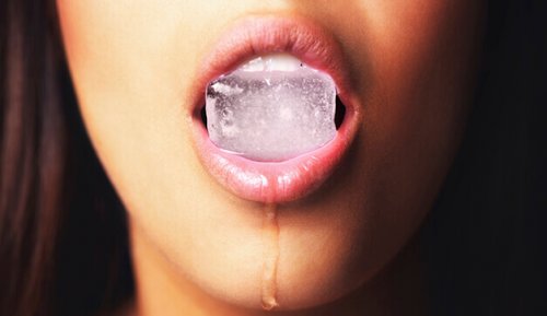 Donna con cubetto di ghiaccio in bocca