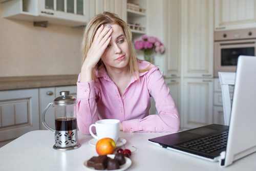 Donna stanca con caffè al pc