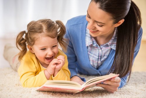 mamma e figlia leggono un libro sul tappeto