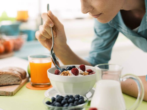 Donna che mangia yogurt con frutti rossi