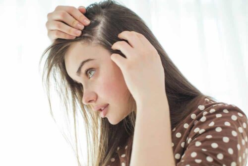 Ragazza che osserva i propri capelli.