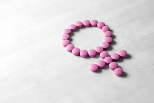 Pillole rosa formano simbolo del sesso femminile