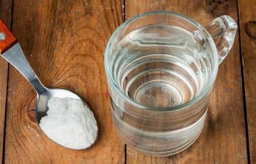 Bicchiere d'acqua e cucchiaino di sale
