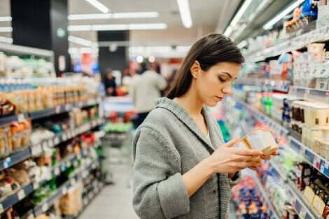 Donna controlla l'etichetta dello yogurt per la sicurezza alimentare.