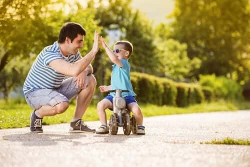 Padre batte il cinque a suo figlio in un parco.