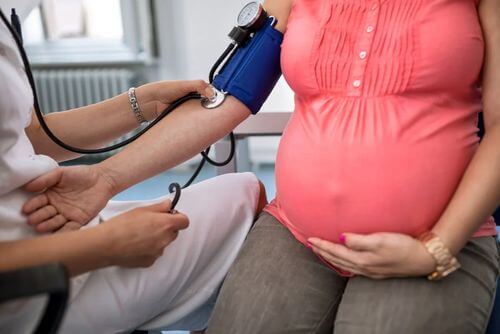 Donna in gravidanza che misura la pressione.