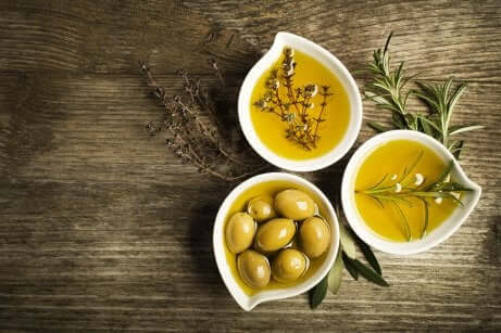 Ciotole con oli di oliva vergini e olive.