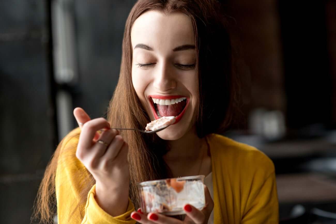 Ragazza sorridente mangia gelato.