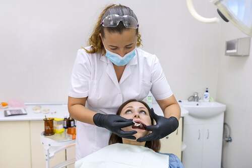 Dentista che esegue estrazione dentale.